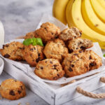 Cookies with oat flakes, bananas and chocolate. Delicious homemade biscuits served with milk.